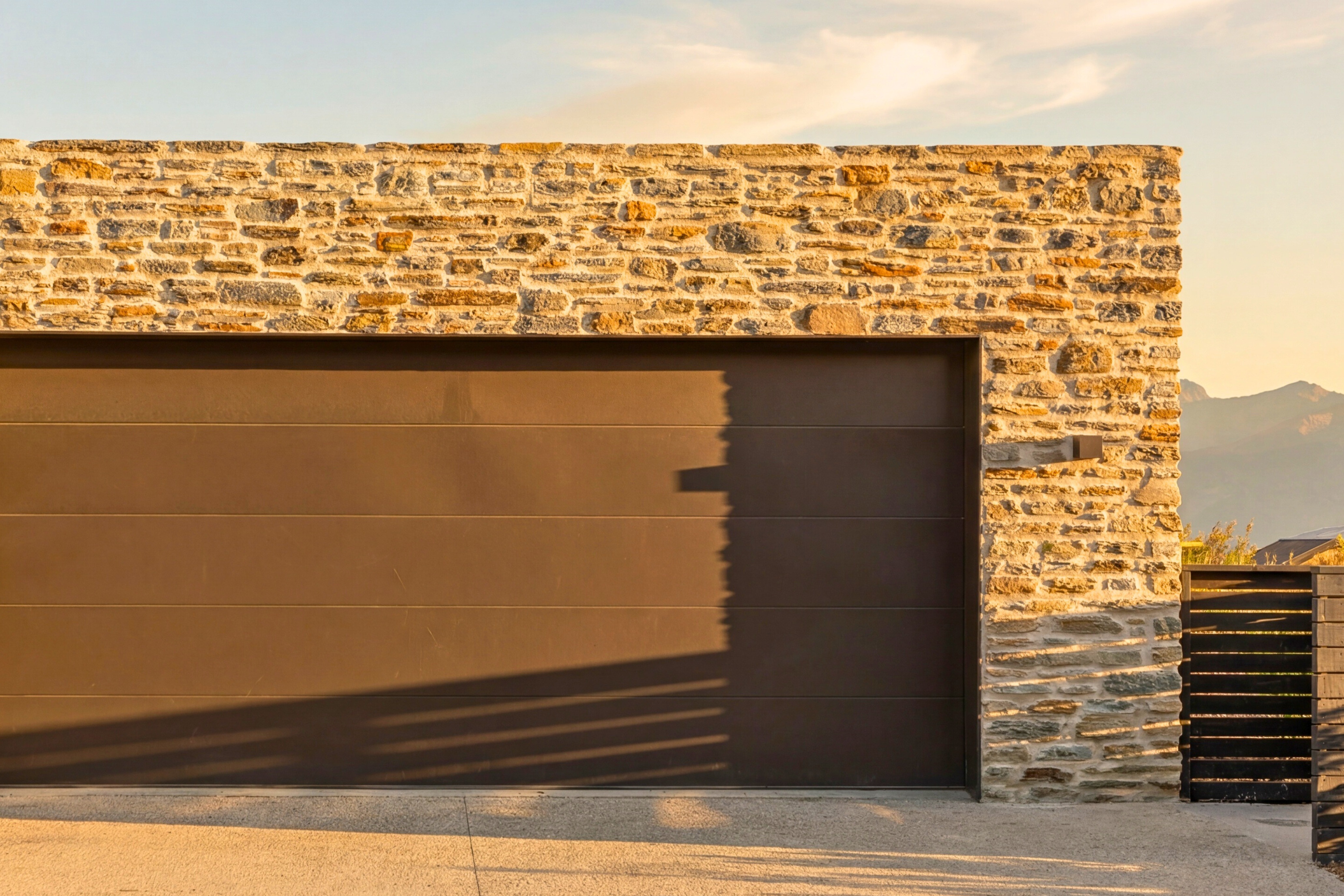 Sheltered outdoor terrace with modern furniture, outdoor fireplace and mountain views